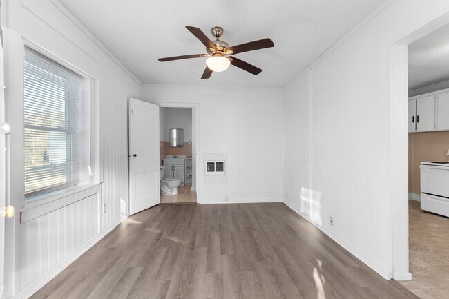 All-new engineered hardwood flooring in living room. Large window facing the downtown clock tower. - 110 Blackman St