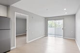 Located at 12200 Valley View St in Garden Grove, California, this one-bedroom, one-bathroom unit offers a thoughtfully arranged single-floor layout designed to maximize every square foot. The open living area is finished with light-toned flooring and soft gray walls, creating a clean, neutral aesthetic throughout. A sliding glass door fills the living space with natural light and provides a view of the outdoors, enhancing the sense of openness.

The kitchen is well-appointed with white shaker-style cabinetry, light countertops, a double-basin sink, and a full suite of stainless steel appliances including a refrigerator, electric range, and built-in microwave. Recessed lighting adds a polished finish to the space.

The bedroom offers a comfortable footprint with a sliding-door closet, a wall-mounted air conditioning unit, and a window that brings in additional natural light. The neutral gray walls and light flooring carry through consistently from the main living area.

The bathroom features a single-sink vanity with white cabinetry and a mirrored medicine cabinet, tile flooring, and a full shower-tub combination. The overall design of this unit is clean, modern, and move-in ready, making it a practical and well-finished residence in the heart of Garden Grove.