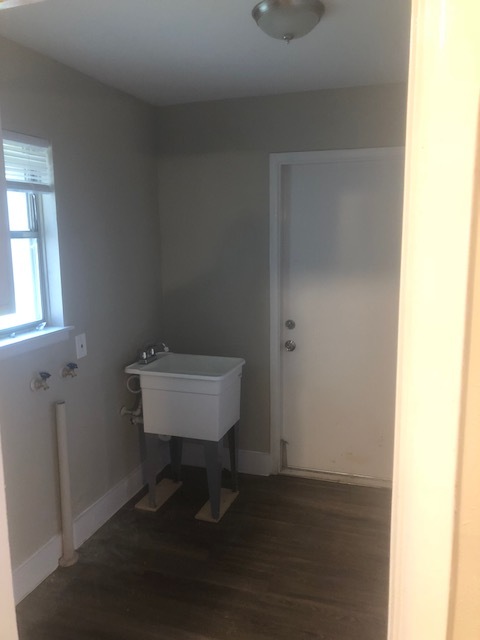 Not only does the laundry room offer a brand new sink and faucet, it has lots of additional storage. - 4802 Wycliff Dr