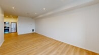 Located at 710-712 Main St in Middletown, CT, this thoughtfully designed one-bedroom, one-bathroom unit offers a clean, modern aesthetic throughout. The open-concept living room and kitchen area is anchored by light hardwood-style flooring and recessed lighting, creating a bright and welcoming atmosphere. Large windows allow natural light to flow through the space, offering views of the surrounding neighborhood.

The kitchen is a standout feature, equipped with stainless steel appliances including a range, over-the-range microwave, dishwasher, and refrigerator. White shaker-style cabinetry extends to the ceiling for ample storage, while granite countertops and a classic white subway tile backsplash add a polished, contemporary touch. An in-unit washer is also conveniently integrated into the kitchen layout.

The generously sized primary bedroom features plush wall-to-wall carpeting, a closet with double doors, and windows that bring in natural light. The full bathroom is finished with large-format marble-look tile on both the floors and tub surround, complemented by a shaker-style vanity and chrome fixtures, offering a clean and refined feel. Throughout the unit, crisp white walls and recessed lighting contribute to a fresh, move-in-ready presentation.