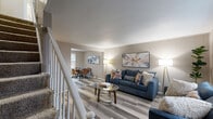 Located at 68 Foster Dr in Willimantic, CT, this two-bedroom, one-bathroom home spans two floors, offering a well-organized and functional layout. The main level features a bright, open living room with light wood-style flooring, neutral warm-toned walls, and windows that invite natural light. The living area flows into a dining space, creating an easy connection between rooms. A white staircase with classic spindle railings leads to the upper level. The kitchen is appointed with crisp white cabinetry, a mosaic tile backsplash, a full suite of appliances including a refrigerator, electric range, microwave, and dishwasher, along with ample counter space. A dedicated laundry area and in-unit closet storage add to the home's practicality. Upstairs, the primary bedroom is a comfortable retreat featuring large windows with neighborhood views and wood-style flooring. The second bedroom includes a built-in closet with louvered doors. The full bathroom offers a tub-shower combination with white tile surround and a window for ventilation. With four closets throughout, this two-floor home provides efficient storage and a cohesive, move-in-ready aesthetic throughout every room.