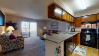 Located at 4816 McMahon Blvd NW in Albuquerque, New Mexico, this single-floor residence offers a functional and well-appointed layout designed for comfortable living. The open-concept kitchen flows seamlessly into the living area, creating a connected and social atmosphere. The kitchen is equipped with warm honey-toned wood cabinetry, light countertops, black appliances including a gas range with overhead ventilation and a full-size refrigerator, and a double sink. A breakfast bar with bar seating bridges the kitchen to the living space, offering a convenient casual dining option. Built-in wall shelving in the living area provides additional storage and display space. The carpeted living room is bright and welcoming, anchored by a large sliding glass door fitted with vertical blinds that open to an outdoor balcony and offer views of the surrounding landscape. The bedroom features plush carpet, a large closet with mirrored sliding doors, a bright window with blinds, and a textured ceiling. The bathroom includes a tub-shower combination, wood-look flooring, dark wood cabinetry with a stone-look countertop, and textured walls. Throughout the residence, a neutral color palette and practical finishes create a cohesive and livable environment.