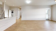 Located at 691 Hoylake Ave in Langford, BC, this well-appointed 2-bedroom, 2-bathroom unit offers a thoughtfully designed open-concept floor plan with a bright, contemporary aesthetic throughout. Light-toned laminate flooring flows seamlessly through the main living areas, complementing the neutral palette of the crisp white walls.

The combined kitchen and living area serves as the heart of the unit. The kitchen features a granite-topped island with an integrated sink, modern flat-front cabinetry, and a full suite of stainless steel appliances including a refrigerator, electric range, and microwave. The open living area is bathed in natural light from large windows and sliding glass doors that lead to one of two private balconies, offering pleasant outdoor views of the surrounding Langford neighbourhood. A ceiling fan adds to the comfort of the space.

The spacious primary bedroom includes its own balcony access via a sliding glass door and benefits from generous closet space. The second bedroom is equally well-sized and features its own walk-in closet with wire shelving. The primary bathroom offers a double-sink granite vanity with ample storage, while the second bathroom features a single-sink vanity with matching finishes and tile flooring. In-unit stacked laundry adds everyday convenience. With four closets total, storage is plentiful throughout.