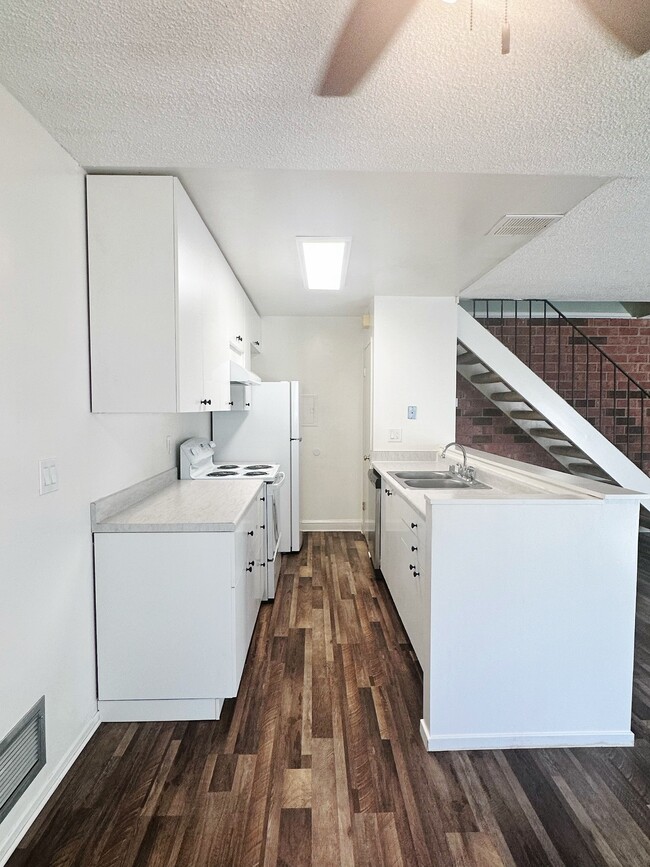 Kitchen view of refrigerator, stove, dishwasher and pantry - 5494 Judith St