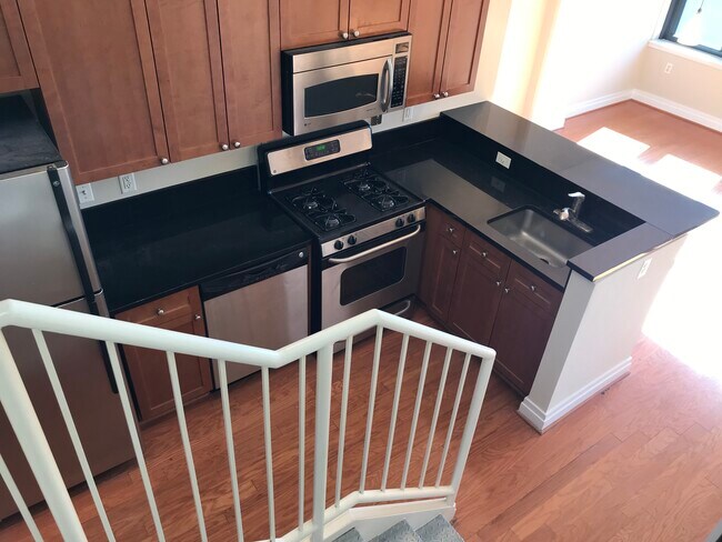 View of the Kitchen from the stairs leading to 2nd level - 2120 Vermont Ave NW