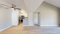 Located at 760 South Hill Road in Ventura, CA, this 2-bedroom, 2-bathroom residence offers a well-designed single-floor layout with a range of modern finishes throughout. The open living area is highlighted by soaring vaulted ceilings and light wood-style flooring, creating a bright and airy atmosphere. A ceiling fan adds comfort, while a sliding glass door opens to a private balcony with lattice railing, offering pleasant views of surrounding greenery.

The kitchen is thoughtfully appointed with white shaker cabinetry, stone-look countertops, a mosaic tile backsplash, and a full suite of stainless steel appliances including a gas range, built-in microwave, dishwasher, and refrigerator.

Both bedrooms feature plush carpeting and mirrored sliding closet doors. The primary bedroom benefits from vaulted ceilings and natural light from windows overlooking the outdoors. Each bathroom is clean and functional—one featuring light wood-style flooring and a tub/shower combo, while the second includes a vanity with white cabinetry and stone-look countertop. Neutral warm-gray tones carry throughout the home, lending a cohesive and modern aesthetic.