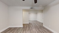 Located in Scottsdale, AZ, this single-story, 3-bedroom, 3-bathroom home offers a clean, modern aesthetic with thoughtful updates throughout. The interior is finished with light wood-look luxury vinyl plank flooring that runs seamlessly across all living areas, complemented by crisp white baseboards and a neutral color palette that creates a bright, cohesive feel.

The living room is a comfortable open area featuring a ceiling fan and textured ceiling, with French doors that invite natural light and provide outdoor access. The kitchen stands out as a highlight of the home, showcasing white shaker-style cabinetry, quartz countertops, a tile backsplash, and a full suite of stainless steel appliances including a range, microwave, dishwasher, and refrigerator. A skylight adds additional brightness to this well-appointed space.

The three bedrooms are well-proportioned and feature windows with blinds for natural light and privacy, including the primary bedroom which offers a comfortable footprint. Two closets provide convenient storage. All three bathrooms are finished with white vanity cabinetry, quartz countertops, undermount sinks, brushed nickel fixtures, and wood-look flooring, with at least one bathroom featuring a tub-shower combination. A connecting hallway ties the layout together efficiently.