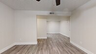 Located in Scottsdale, AZ, this single-story, 3-bedroom, 3-bathroom home offers a clean, modern aesthetic with thoughtful updates throughout. The interior is finished with light wood-look luxury vinyl plank flooring that runs seamlessly across all living areas, complemented by crisp white baseboards and a neutral color palette that creates a bright, cohesive feel.

The living room is a comfortable open area featuring a ceiling fan and textured ceiling, with French doors that invite natural light and provide outdoor access. The kitchen stands out as a highlight of the home, showcasing white shaker-style cabinetry, quartz countertops, a tile backsplash, and a full suite of stainless steel appliances including a range, microwave, dishwasher, and refrigerator. A skylight adds additional brightness to this well-appointed space.

The three bedrooms are well-proportioned and feature windows with blinds for natural light and privacy, including the primary bedroom which offers a comfortable footprint. Two closets provide convenient storage. All three bathrooms are finished with white vanity cabinetry, quartz countertops, undermount sinks, brushed nickel fixtures, and wood-look flooring, with at least one bathroom featuring a tub-shower combination. A connecting hallway ties the layout together efficiently.
