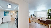 Located at 1101 Craftsman Dr in Virginia Beach, VA, this single-story home offers a thoughtfully designed layout with a seamless flow between living spaces. The living room is bright and welcoming, featuring light hardwood-style flooring, a large window that draws in natural light and outdoor views, and an open connection to the rest of the home. Adjacent to the living area, a dedicated sitting or flex space provides additional room for relaxation or entertaining.

The kitchen is efficiently designed with white shaker-style cabinetry, black hardware accents, a gas range, dishwasher, and black refrigerator. A tray ceiling adds architectural interest, while light flooring ties the space together. A separate dining room accommodates a full-size dining table and chairs, with a window overlooking greenery outside, making it ideal for gatherings.

The bedrooms are carpeted and generously sized, with multiple windows offering natural light and views of the surrounding landscape. The primary bedroom provides ample space for a full furniture arrangement. The bathroom features a clean, all-white design with a walk-in shower, updated vanity, and light wood flooring. Throughout the home, a neutral color palette and consistent finishes create a cohesive, modern aesthetic.
