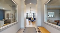 Located at 14158 S Hilltop Ln in Lockport, IL, this single-floor community clubhouse offers a thoughtfully designed layout across a generous footprint. The welcoming entry hallway features a dramatic arched ceiling, warm wood-look flooring, and flanking mirrors that create an immediate sense of openness and style. A bench and natural light set a polished first impression.

The expansive living room serves as the heart of the space, showcasing soaring vaulted ceilings, a striking floor-to-ceiling accent wall with a linear fireplace, built-in shelving with decorative wood accents, and a mounted flat-screen television. Large windows flood the area with natural light, while a statement sputnik chandelier adds a modern touch. The adjacent dining area features a bold navy shiplap accent wall and natural light from a window, creating an intimate yet stylish setting.

The kitchen is appointed with crisp white cabinetry, quartz countertops, a decorative tile backsplash, stainless steel appliances, and pendant lighting over a central island — offering a bright and functional space with a view of the outdoor pool area.

The dedicated exercise room is well-equipped with cardio machines, free weights, strength equipment, wall-mounted televisions, and ample natural light from large windows, making it a comprehensive fitness facility.