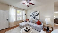 Located in Estero, Florida, this single-story 2-bedroom, 2-bathroom home offers a thoughtfully designed layout that maximizes comfort and functionality. The open-concept living, dining, and kitchen area serves as the heart of the home, with hardwood-style flooring, neutral-toned walls, and a ceiling fan that enhances airflow throughout. Large windows flood the living room with natural light, offering pleasant outdoor views and a bright, welcoming ambiance.

The kitchen is equipped with dark espresso cabinetry, granite-style countertops, black appliances, and a breakfast bar with pendant lighting overhead — ideal for casual dining or entertaining. A built-in wine rack adds a distinctive touch to the cabinetry.

The primary bedroom features carpeted flooring, large windows that invite natural light, and ample closet space. The second bedroom is equally comfortable, with a ceiling fan and cozy atmosphere. Both bathrooms are finished with wood-style flooring, dark vanity cabinetry, and a tub-shower combination. The dedicated laundry room houses a full-size washer and dryer. With four closets throughout, storage is plentiful in this efficiently designed Estero residence.