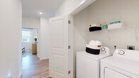 Located on Moreland Ave SE in Atlanta's vibrant 30316 neighborhood, this single-level residence offers a well-appointed 2-bedroom, 2-bathroom layout designed for comfortable, modern living. Light wood-look flooring flows throughout, tying together a bright, cohesive aesthetic.

The living room is a standout feature, bathed in natural light from multiple large windows dressed with sheer draping curtains and blinds. A ceiling fan adds comfort, while the open feel of the space makes it ideal for both relaxing and entertaining.

The kitchen is sleek and functional, showcasing granite countertops, a generous island with seating potential, light wood cabinetry, stainless steel appliances, a subway tile backsplash, and open shelving. It connects seamlessly to the living area, enhancing the open-plan flow.

Both bedrooms are well-sized and filled with natural light through large windows. The primary bedroom is a comfortable retreat with a ceiling fan and walk-in closet featuring wire shelving. The second bedroom is cozy and equally bright.

Each bathroom is finished with granite vanity countertops, white cabinetry, and clean tile work. One bathroom includes a tub-shower combo, while the other features a streamlined design. An in-unit laundry area with washer and dryer hookups and overhead shelving adds everyday convenience.