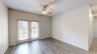 This single-story, 2-bedroom, 2-bathroom home in Edinburg, Texas offers a functional and well-appointed layout designed for comfortable everyday living. Wood-look flooring flows consistently throughout the home, lending a cohesive and modern aesthetic to every room.

The open living area is bright and inviting, featuring a ceiling fan, a French door entry that allows natural light to fill the space, and neutral walls that complement a variety of décor styles. The kitchen is equipped with dark espresso cabinetry extending to the ceiling for ample storage, light-toned countertops, a built-in sink, and black appliances including a range, microwave, and dishwasher.

Both bedrooms are comfortably sized, with the primary bedroom offering a generous footprint, ceiling fan, and a window with outdoor views. The second bedroom also features a ceiling fan and natural light. Each bathroom is outfitted with dark cabinetry, a tub-shower combo with neutral tile surround, and wood-look flooring. A dedicated laundry area with a top-load washer and overhead wire shelving adds everyday convenience. A closet and hallway complete the thoughtful floor plan of this move-in-ready Edinburg home.
