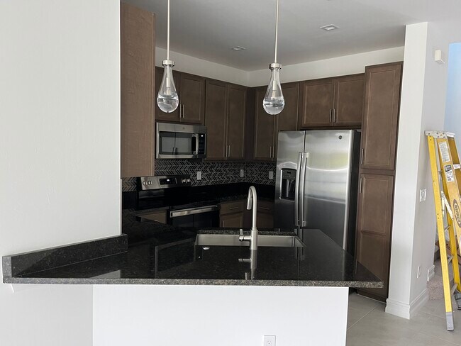 Kitchen with under cabinet lighting - 7498 Rockefeller Dr