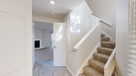 This two-story home in Westminster, Colorado offers a thoughtfully laid-out floor plan across two levels. The main floor features an open-concept living and kitchen area, where a peninsula counter with a built-in sink connects the two spaces seamlessly. The kitchen is equipped with stainless steel appliances, white cabinetry, and a subway tile backsplash, all illuminated by recessed lighting. The living room is bright and inviting, highlighted by a white-surround fireplace with a tile hearth, a ceiling fan, and hard surface flooring that transitions to plush carpet. Natural light filters through multiple windows dressed with horizontal blinds throughout the home. Carpeted stairs lead to the upper level, where three bedrooms are located, each featuring soft carpet, windows with natural light, and closets with bi-fold doors and built-in rods. The primary bedroom is a comfortable retreat with its own dedicated closet. Four bathrooms serve the home, each finished with clean white vanities, quartz-style countertops, brushed nickel fixtures, and mirrored medicine cabinets. The tiled bathtub-shower combinations are bright and functional. A hallway connects the upper-level rooms, completing this well-organized and move-in-ready home.