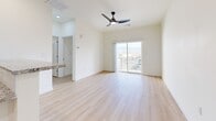 Located at 2211 Rio Grande Blvd NW in Albuquerque, New Mexico, this modern 2-bedroom, 2-bathroom residence offers a thoughtfully designed single-floor layout. Light wood-tone flooring flows throughout, complementing the bright, neutral palette that gives the space an open and airy feel.

The open-concept living, dining, and kitchen area serves as the heart of the home. The kitchen is well-appointed with crisp white shaker cabinetry, granite countertops, stainless steel appliances including a range, microwave, and refrigerator, and a peninsula with a undermount sink — ideal for both cooking and casual dining. The living area extends naturally toward a sliding glass door that opens to a private balcony, offering scenic views of the surrounding Albuquerque landscape and distant mountains.

The spacious primary bedroom features a ceiling fan with integrated lighting and a generous walk-in closet with built-in shelving and hanging rods. The second bedroom is equally bright, benefiting from natural light and a ceiling fan. Both bathrooms are finished with sleek marble-style tiled tub/shower surrounds and brushed gold fixtures, combining elegance with practicality. Additional conveniences include an in-unit laundry area and three closets total for ample storage throughout.