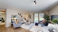 Located at 140 Crestview Blvd in Commerce Township, MI, this well-appointed one-bedroom, one-bathroom residence offers a thoughtfully designed single-floor layout. The open-concept living area features wood-look flooring, track lighting, and a sliding glass door that floods the space with natural light while providing access to an outdoor view of lush greenery. The kitchen is outfitted with crisp white shaker cabinetry, quartz countertops, a subway tile backsplash, stainless steel appliances including a refrigerator, range, and microwave, and a peninsula with pendant lighting that connects seamlessly to the living area. The spacious primary bedroom is carpeted and features a striking navy accent wall, a large window for natural light, and ample room for a full bedroom suite. Four closets, including a generously sized walk-in with wire shelving, provide exceptional storage throughout. The full bathroom offers a vanity with white cabinetry, tile flooring, and a shower-tub combination. A dedicated in-unit laundry room accommodates a full-sized washer and dryer. Neutral tones, modern finishes, and a practical floor plan come together to create a comfortable, functional living environment.