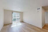 This contemporary single-story residence, located at 265 Templeton St in San Diego, CA, offers 870 square feet of efficiently designed living space. The home features three bedrooms, including a spacious 150 square foot primary bedroom, and two full bathrooms. The open-concept floor plan seamlessly integrates the kitchen and living room, creating a cohesive and inviting atmosphere. The kitchen boasts modern white cabinetry, stainless steel appliances, and a sleek countertop, perfect for culinary enthusiasts. Large windows and sliding glass doors in multiple rooms flood the space with natural light and provide access to outdoor balconies, expanding the living area and offering views of the surroundings. Light-colored walls and light wood flooring throughout contribute to a bright and airy ambiance. The bathrooms are equipped with modern fixtures, including a combination bathtub and shower. This home's design prioritizes functionality and style, making it an ideal choice for those seeking a contemporary living space in a desirable San Diego neighborhood.