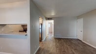 Located at 8404 N Loop Dr in El Paso, Texas, this single-floor unit offers a straightforward, functional layout with consistent design elements throughout. The open living area welcomes you with warm wood-look flooring and neutral-toned walls, creating a bright and inviting atmosphere. Multiple windows dressed with blinds allow natural light to flow through the space, enhancing its clean, airy feel.

The kitchen is efficiently designed with white cabinetry, gray countertops, a stainless steel refrigerator, a built-in dishwasher, and a stainless steel sink — all framed by a pass-through opening that connects it to the living area. A hallway leads from the living space to the private areas of the unit.

The bedrooms are well-proportioned, each featuring wood-look flooring, ceiling fans with light fixtures, and windows that bring in natural light. The rooms offer a calm, neutral palette suited for a variety of furnishing styles. A full bathroom includes a white vanity with ample storage, a tiled shower-tub combination, and wood-look flooring that ties the space together cohesively.

Throughout the unit, textured ceilings, clean white baseboards, and consistent flooring create a unified, well-maintained aesthetic that is both practical and comfortable.
