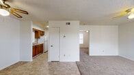 Located at 1558 E 16th St in Russellville, Arkansas, this single-floor, 2-bedroom, 1-bathroom unit offers a practical and straightforward layout. The living area features a combination of tile and carpet flooring, a ceiling fan, and a textured ceiling, creating a comfortable and functional common space that transitions naturally into the kitchen and bedrooms.

The galley-style kitchen is equipped with warm wood cabinetry — both upper and lower — a double-basin sink, a white electric range, and a full-size refrigerator. Tile flooring runs throughout the kitchen, complementing the cabinetry tones.

The generously sized primary bedroom is carpeted and includes a ceiling fan, a walk-in closet with built-in shelving, and a sliding wood-panel closet door, offering ample storage. The second bedroom is also carpeted, features a ceiling fan, and is brightened by a window with natural light. A third carpeted room visible in the layout provides additional flexible space.

The bathroom is clean and bright, featuring a wood-vanity with a single sink, a full tub-shower combination, tile flooring, and white walls. HVAC vents are present throughout, ensuring climate control across the unit. Overall, the space presents a no-frills, functional living environment suited for comfortable everyday use.