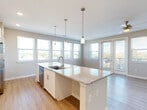 Located at 816 Addicks Howell Rd in Houston, TX, this well-appointed 2-bedroom, 2-bathroom single-story home offers a thoughtfully designed open-concept layout. The combined living and dining area is bright and airy, featuring light wood-style flooring, neutral toned walls, a ceiling fan, and French doors flanked by large windows that invite abundant natural light and outdoor views. The modern kitchen is a standout, showcasing a generous granite-topped island with an undermount sink and pendant lighting overhead. White shaker cabinetry, a subway tile backsplash, stainless steel appliances, and additional recessed lighting complete the space, which flows seamlessly into the living and dining areas. Both bedrooms are carpeted and well-sized, each offering ceiling fans and windows with exterior views. The primary bedroom is a comfortable retreat with its own closet access. The bathrooms are clean and functional, with one featuring a soaking tub and shower combination with brushed gold fixtures and wood-style flooring. Additional spaces include an entrance, hallway, pantry, laundry room, and three closets, providing ample storage throughout this efficiently organized home.