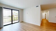 Located at 1905 Champs Drive in Naples, FL, this thoughtfully designed 4-bedroom, 3-bathroom unit offers a clean, modern aesthetic across a single floor. The open-concept kitchen and living area serves as the heart of the home, featuring crisp white shaker cabinetry, a subway tile backsplash, a large center island with quartz countertops, and a full suite of stainless steel appliances. Light wood-tone flooring flows seamlessly throughout the entire unit, creating a warm and cohesive atmosphere. The living area is bright and open, with access to a sliding glass door that welcomes natural light. Each of the four bedrooms is well-proportioned and finished with the same light wood flooring; several rooms include ceiling fans and windows with outdoor views of surrounding greenery. The primary bedroom is generously sized and features a dedicated walk-in closet outfitted with multi-tiered wire shelving for ample storage. The three bathrooms are consistently finished with white subway tile tub-shower combinations, white vanities with quartz countertops, and brushed nickel hardware. Recessed lighting throughout the unit adds a polished, contemporary feel, while the neutral color palette and clean lines create a bright, move-in ready environment.