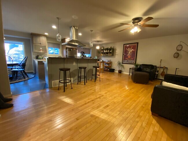 Open kitchen with bar and barstools and den - 938 Mercury Cir