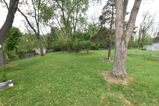 Huge fenced in backyard with firepit and mature trees - 10195 Cedar Island Rd