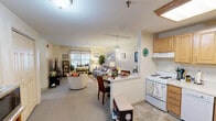Located at 619 Hartford Road in Manchester, Connecticut, this single-floor residence offers a thoughtfully organized layout encompassing a bedroom, bathroom, office, closet, and a combined kitchen and living area. The open-concept kitchen and living room serve as the heart of the home, where light maple cabinetry, white appliances including a range, dishwasher, and refrigerator, and tile flooring define a functional kitchen space. A peninsula counter provides a natural transition into the dining and living areas, which feature soft carpet flooring, neutral walls, and a window with a decorative valance that invites natural light. The living area is warm and comfortable, offering ample room for seating and entertainment. The spacious primary bedroom is a serene retreat, featuring plush carpeting, large windows with valances, and two generous double-door closets providing abundant storage. The full bathroom includes a tub-shower combination with a curtain surround and clean, neutral finishes. A versatile office space with a window and carpet flooring offers flexibility for hobbies, remote work, or exercise. Throughout, the residence maintains a cohesive, cozy ambiance with warm neutral tones, practical layouts, and comfortable finishes suited for everyday living.