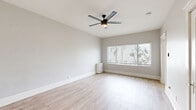 Located at 1133-1137 27th St in San Diego, CA, this single-story unit offers a well-organized layout with one bedroom, two bathrooms, and a kitchen. Throughout the space, light wood-style flooring lends a clean, cohesive aesthetic, complemented by neutral gray walls and crisp white baseboards and trim.

The generously sized bedroom is a standout feature, accommodating comfortable furnishings with ease. A modern ceiling fan with an integrated light fixture keeps the room airy, while a wide window fitted with horizontal blinds fills the space with natural light and offers views of palm trees outside. A dedicated closet with a clothing rod provides practical storage.

The kitchen is thoughtfully designed with white shaker-style cabinetry, brushed gold hardware, and warm gray countertops. Stainless steel appliances — including a gas range and over-the-range microwave — add a modern touch, and a window above the sink brings in additional natural light.

One bathroom features a charming clawfoot soaking tub with an attached shower fixture, a toilet, and a small window for ventilation — a classic detail that adds character to the space. The second bathroom provides additional convenience for residents.

The entry area offers a clean, open transition into the living space, complete with a decorative paneled door. The overall ambiance is bright, fresh, and move-in ready.