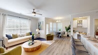 Located at 1310 Silver Sage Dr in Raleigh, NC, this one-bedroom, one-bathroom residence offers a thoughtfully designed single-story layout with a warm, neutral palette and wood-look flooring carried throughout. The open-concept living and dining area is bright and welcoming, featuring crown molding, a large bay window that floods the space with natural light, and a chandelier overhead. An adjacent built-in desk area adds a functional workspace seamlessly integrated into the layout. The kitchen is well-appointed with white shaker cabinetry, a subway tile backsplash, stainless steel appliances, and a quartz peninsula with bar seating — ideal for casual dining or entertaining. The bedroom is a comfortable retreat with a ceiling fan, a generous window with views of surrounding greenery, and direct access to a spacious walk-in closet outfitted with wire shelving. The full bathroom features a tiled tub/shower combination, a quartz vanity, and wood-look flooring. A dedicated laundry area houses a full-size washer and dryer along with an elevated water heater, providing added convenience. The overall ambiance is clean, modern, and move-in ready.