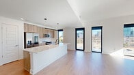 This contemporary 3-bedroom, 3-bathroom apartment in Atlanta offers 1110 square feet of thoughtfully designed living space. The open-concept layout seamlessly integrates the kitchen, living, and dining areas, creating an expansive feel. The kitchen boasts modern appliances, light wood cabinetry, and a large island with a white countertop, perfect for casual dining or entertaining.

Floor-to-ceiling windows flood the space with natural light and provide stunning city views, while also offering access to a private balcony. The bedrooms, including a 160 square foot primary suite, feature hardwood floors and ample closet space. The bathrooms are sleek and modern, with floating vanities, large mirrors, and stylish fixtures.

The apartment's neutral color palette, with white walls and warm wood tones, creates a versatile backdrop for any decor style. Additional features include a ceiling fan for comfort, recessed lighting, and a separate laundry area. The building's location at 10 Tower Rd NW in Atlanta (30363) ensures residents are close to urban amenities while enjoying the comfort of this well-appointed home.