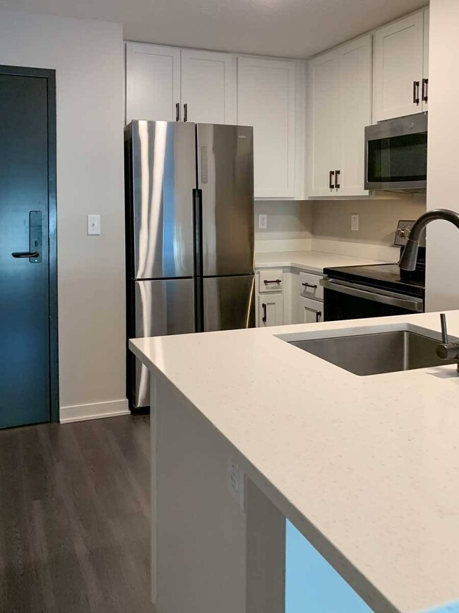 Cook up something special in this fully equipped, modern kitchen with stainless steel appliances. - The Knock Apartments