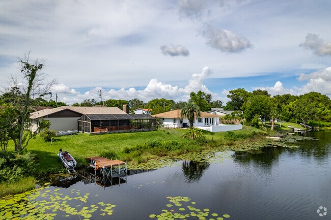 A row of waterfront ranch-style home with with boat docks on Clear Lake in Deltona.