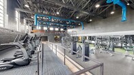Located at 3201 First Ave in Columbus, Georgia, this single-floor fitness facility occupies a generously sized space that delivers an impressive, industrial-inspired workout environment. The building's architecture is defined by its soaring ceilings with exposed steel trusses, painted brick walls in deep charcoal tones, and bold blue HVAC ductwork that runs overhead, adding a striking visual contrast throughout the space.

The main workout floor is divided into distinct zones to accommodate a wide range of training styles. A dedicated cardio area lines one side of the facility, featuring a long row of True-brand treadmills and elliptical machines positioned beneath tall, multi-pane windows that flood the space with natural light. Adjacent to this, a comprehensive strength training zone houses a full array of selectorized machines, free weights, and a dumbbell rack set against a vibrant blue accent wall.

A functional training area features a large power rack structure complete with climbing ropes, gymnastic rings, and a rope climbing net, all set on durable rubber flooring. Large mirrors amplify the sense of space throughout the strength zones. The entry area transitions seamlessly via light wood-look flooring, with a staircase leading to an upper mezzanine level. A dedicated accessory room offers stability balls, medicine balls, and benches for supplemental training. The facility combines raw industrial character with modern fitness amenities.