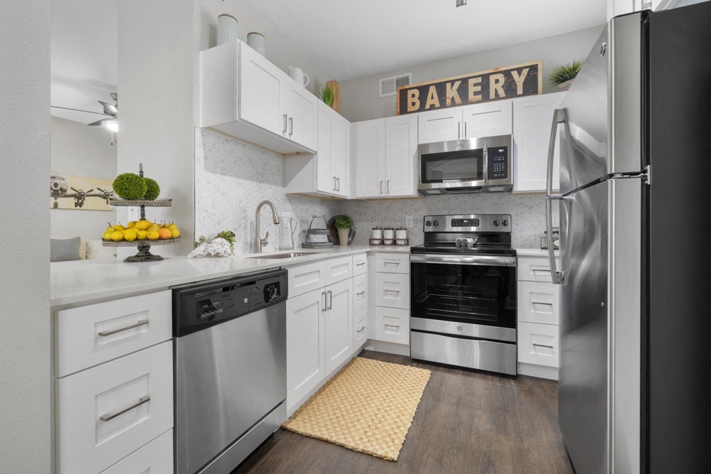 Platinum White Scheme - Newly Renovated Kitchens with GE Stainless Steel Appliances, Custom Cabinetry with Soft-Close Doors and Drawers, and White Marble or Grey Quartz Countertops - Flatiron District at Austin Ranch