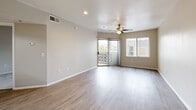 Located at 1333 N 24th St in Phoenix, AZ, this one-bedroom, one-bathroom unit offers a thoughtfully arranged single-floor layout. The open-concept living room and kitchen area is anchored by wood-look flooring, neutral warm-toned walls, and a ceiling fan that keeps the space feeling airy. A sliding glass door floods the living area with natural light and provides access to a private outdoor balcony, enhancing the sense of openness.

The kitchen is efficiently designed with light wood cabinetry, dark countertops, a stainless steel sink, and a full suite of white appliances including a refrigerator, electric range, and microwave. Conveniently accessible from the kitchen is a dedicated laundry room housing a full-size washer and dryer alongside a water heater.

The bedroom is comfortably sized, finished with plush carpet, a ceiling fan, and a walk-in closet, offering practical storage. A window provides natural light and access to an outdoor view. The full bathroom features wood-look flooring, a combined tub and shower, a toilet, and a vanity with warm wood-toned cabinetry topped by a framed mirror. The overall aesthetic throughout is clean, neutral, and move-in ready.