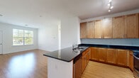 Located at 417 Raritan Road in Roselle, NJ, this well-appointed single-floor home offers three bedrooms, two bathrooms, and a thoughtfully designed layout. Light-toned hardwood-style flooring flows throughout the main living areas and hallways, lending a clean, cohesive feel to the space.

The kitchen is a standout feature, equipped with warm-toned wood cabinetry extending to the ceiling, dark granite countertops, and a full suite of stainless steel appliances including a gas range, microwave, and refrigerator. A center island with an integrated sink adds both functionality and style, and the kitchen opens naturally toward the living area, creating an easy flow for everyday living.

The three bedrooms are bright and comfortable, each featuring plush carpeting and windows dressed with blinds that allow for natural light and outdoor views. The primary bedroom includes its own closet and hardwood-style flooring. Two hallways connect the rooms efficiently, with an additional closet providing convenient storage.

The two bathrooms are finished in clean white tile. One features a sleek glass-enclosed walk-in shower, while the other includes a full soaking tub with subway tile surround. Together, they offer practical yet polished accommodations. The overall ambiance of the home is light, neutral, and move-in ready.
