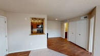 Located at 3440 E Rosemeade Pkwy in Dallas, TX, this single-floor unit offers a practical and well-organized layout with a comfortable blend of materials and finishes throughout. The open living and dining area is anchored by rich hardwood-style flooring, transitioning to plush carpet in the main living space. A distinctive pass-through window connects the kitchen to the living area, providing an open feel while maintaining defined zones. The kitchen is fully equipped with warm-toned wood cabinetry, granite-style countertops, black appliances including a refrigerator, electric range, and built-in microwave, all illuminated by recessed and track lighting. The bedroom features wall-to-wall carpet, a ceiling fan with light fixture, and a generously sized window fitted with blinds that allow natural light to filter in while maintaining privacy. A second carpeted room with a sliding glass door opens to an outdoor view, adding versatility to the floor plan. The bathroom is neatly appointed with a granite-top vanity, a tub-shower combination, and wood-style flooring. Textured ceilings are found throughout the unit, and ample closet storage is accessible from the main living corridor.