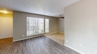 Located at 4861 N Blackwelder Ave in Oklahoma City, Oklahoma, this single-story, one-bedroom, one-bathroom home offers a well-organized layout across a compact and functional floor plan. The living room is bright and welcoming, featuring wood-look laminate flooring, a ceiling fan with light fixture, and large windows with blinds that invite an abundance of natural light. A sliding glass door provides additional outdoor access and further enhances the open, airy feel of the space. The kitchen features tile flooring, white cabinetry, light countertops, and includes a full-size refrigerator. A set of double doors within the kitchen provides convenient storage or pantry access. The generously sized primary bedroom is carpeted for comfort and includes a ceiling fan, a window for natural light, and two closet doors offering substantial storage. The bathroom features a marble-patterned vanity countertop, white cabinetry, a wall-mounted light fixture, and a separate enclosed area with a toilet and bathtub. Neutral warm-gray tones throughout the home, textured ceilings, and clean white trim create a cohesive and understated aesthetic that is easy to personalize.