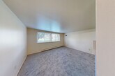 Located at 7300 Central Ave in Westland, MI, this one-bedroom, one-bathroom unit offers a practical and well-organized single-floor layout. The spacious living room is a standout feature, with soft carpeting underfoot, neutral walls, and a pair of large windows that flood the room with natural light and offer views of the surrounding greenery. A baseboard heating system runs along the exterior wall, ensuring year-round comfort.

The combined dining and kitchen area transitions seamlessly from the living space. The kitchen features light wood-look vinyl flooring, dark wood cabinetry with ample upper and lower storage, a stainless steel sink, white countertops, and included appliances — providing a functional cooking environment.

The bedroom is a comfortable size, finished with plush carpet, a dedicated closet, and a second closet nearby. Throughout the unit, four closets total offer exceptional storage capacity. A hallway connects the main living areas to the bathroom, which includes a full soaking tub with shower, a window for natural ventilation and light, vinyl plank flooring, and a vanity with a white countertop and mirror. The entrance provides a welcoming transition into the unit's clean, neutral interior.