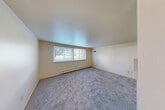 Located at 7300 Central Ave in Westland, MI, this one-bedroom, one-bathroom unit offers a practical and well-organized single-floor layout. The spacious living room is a standout feature, with soft carpeting underfoot, neutral walls, and a pair of large windows that flood the room with natural light and offer views of the surrounding greenery. A baseboard heating system runs along the exterior wall, ensuring year-round comfort.

The combined dining and kitchen area transitions seamlessly from the living space. The kitchen features light wood-look vinyl flooring, dark wood cabinetry with ample upper and lower storage, a stainless steel sink, white countertops, and included appliances — providing a functional cooking environment.

The bedroom is a comfortable size, finished with plush carpet, a dedicated closet, and a second closet nearby. Throughout the unit, four closets total offer exceptional storage capacity. A hallway connects the main living areas to the bathroom, which includes a full soaking tub with shower, a window for natural ventilation and light, vinyl plank flooring, and a vanity with a white countertop and mirror. The entrance provides a welcoming transition into the unit's clean, neutral interior.