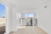 Located at 5570 Rosemead Blvd in Temple City, California, this contemporary space offers a clean, minimalist design that maximizes both light and functionality. The interior room is finished with smooth white walls and light-toned hardwood flooring that lends a warm, airy feel to the space. Recessed lighting in the ceiling complements the abundant natural light that pours in through a large sliding glass door, which serves as the seamless transition point between the interior and the outdoor area.

Stepping through the sliding door leads directly onto a generous rooftop terrace finished with wood-look porcelain tile flooring, creating a cohesive and stylish outdoor environment. The terrace is enclosed by stucco parapet walls and offers an expansive, unobstructed panoramic view of the surrounding Temple City neighborhood, with a striking mountain backdrop visible on the horizon. Palm trees, rooftops, and open sky stretch out in every direction, providing a truly elevated outdoor living experience.

The overall ambiance of the space is bright, open, and modern, with a neutral color palette throughout both the interior and exterior areas. The thoughtful integration of indoor and outdoor spaces, combined with the exceptional rooftop views, makes this a uniquely appealing and versatile setting in the San Gabriel Valley.