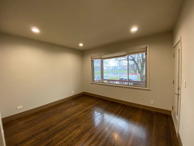 Bright Living room looking out to the park across the street - 2850 W Henderson St