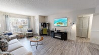 Located at 4008 Lake Underhill Rd in Orlando, Florida, this single-floor residence offers a well-organized and thoughtfully designed layout. The living room serves as the heart of the home, featuring wood-style flooring, a textured ceiling, and multiple windows fitted with blinds and drape panels that invite an abundance of natural light. The space is versatile, accommodating both a comfortable seating arrangement and a dedicated work-from-home desk area, alongside a media console with an electric fireplace insert.

The galley-style kitchen is efficiently laid out with crisp white cabinetry, light quartz-style countertops, a stainless steel sink, and stainless steel appliances including a range, microwave, and refrigerator. A separate dining area features wood-style flooring, chair rail molding, recessed lighting, and wall art, providing a defined space for meals and entertaining.

The bedroom offers plush carpeting, a ceiling fan with light fixture, and direct access to a spacious walk-in closet with built-in shelving. The bathroom is clean and bright, featuring a tub-shower combination, a single-sink vanity with white cabinetry, and wood-style flooring. Throughout the residence, a neutral color palette and consistent flooring choices create a cohesive and inviting atmosphere.