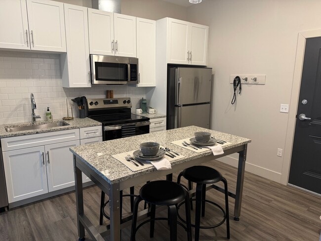 Kitchen and dining with thoughtful details - Triton at the Flats Apartments