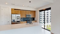 This contemporary apartment, located at 10 Tower St NW, offers 1170 square feet of meticulously designed living space. The single-floor layout comprises 3 bedrooms, 4 bathrooms, and an open-concept kitchen and living area. The primary bedroom, measuring 140 square feet, provides a spacious retreat.

Throughout the apartment, light wood flooring creates a warm, inviting atmosphere, complemented by crisp white walls that enhance the sense of space and light. Large windows in the living areas and bedrooms offer stunning city views and flood the rooms with natural light.

The modern kitchen features sleek wooden cabinetry, stainless steel appliances, and a generous island with a built-in sink, perfect for both meal preparation and casual dining. The bathrooms boast a minimalist design with floating vanities, illuminated mirrors, and high-end fixtures.

Ample storage is provided by two dedicated closet spaces and built-in shelving. The apartment also includes a hallway connecting the various rooms. Ceiling fans in the bedrooms offer additional comfort and air circulation.

This well-appointed apartment combines functionality with contemporary style, creating an ideal urban living space with attention to detail and quality finishes throughout.