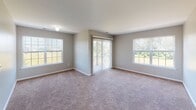 This single-floor residence at Somerset Park in Somerset, NJ offers a well-designed layout across three bedrooms and two full bathrooms. The kitchen serves as a standout feature, showcasing rich dark espresso cabinetry with sleek hardware, deep granite countertops, a stone tile backsplash, and wood-look flooring. Stainless steel appliances—including a gas range, built-in microwave, dishwasher, and refrigerator—complete the functional and polished cooking space.

The bedrooms are finished with neutral-toned carpet and light gray walls, creating a calm and versatile atmosphere. Each bedroom benefits from natural light through large windows fitted with blinds, offering views of surrounding greenery. The primary bedroom is notably spacious and features a sliding glass door that opens to an outdoor area, flanked by multiple windows that invite abundant natural light.

Both bathrooms are finished with white tile wainscoting, light tile flooring, and dark vanity cabinetry with integrated sinks. One bathroom includes a walk-in shower with a glass door, while the second features a window for added ventilation and natural light. The overall design throughout is clean, consistent, and functional.