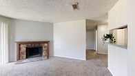 This single-story residence in Temple, TX offers 850 square feet of thoughtfully designed living space. The home features two bedrooms, including a spacious 160 square foot primary bedroom, and three full bathrooms for added convenience. The heart of the home is a combined kitchen and living area, showcasing a striking stone fireplace as its focal point. The galley-style kitchen is equipped with modern appliances and ample counter space, while the living room benefits from natural light through sliding glass doors. Plush carpeting throughout the main living areas adds comfort and warmth. Storage is well-considered with two dedicated closet spaces. The bathrooms are functional, with one featuring a bathtub-shower combination. A ceiling fan in one of the bedrooms provides additional comfort. The home's neutral color palette and textured ceilings create a cohesive, contemporary feel throughout. Outside, windows offer views of the surrounding area, connecting the interior to its Temple, TX setting. This efficiently designed home balances functionality with comfort, making it an ideal option for those seeking a manageable living space.