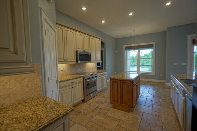 Building Photo - 4-bedroom, 3-bath and 3.5-car garage on pond